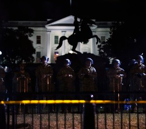 With the White House in the background, a line of police forms behind a fence in Lafayette Park as demonstrators gather to protest the death of George Floyd, Tuesday, June 2, 2020, in Washington. (Photo/AP)
