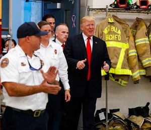 President Donald Trump gives a thumbs up as he arrives to meet with first responders at West Palm Beach Fire Rescue.
