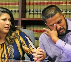 Sub. Orlando Police Officer Gerry Realin, right, becomes emotional, wipes tears from his eyes as his wife Jessica shares her feelings during an interview Thursday, August 11, 2016 almost 2 months since the Pulse nightclub shooting massacre. (Red Huber/ Orlando Sentinel/TNS)