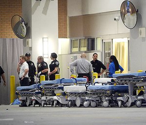 In this June 12, 2016, file photo,emergency personnel wait with stretchers at the emergency entrance to Orlando Regional Medical Center hospital for the arrival of patients from the scene of a fatal shooting at Pulse Orlando nightclub in Orlando, Fla.