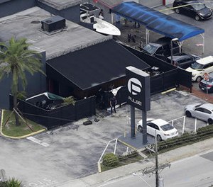 In this June 12, 2016 file photo, law enforcement officials work at the Pulse gay nightclub in Orlando, Fla., following the a mass shooting. (AP Photo/Chris O'Meara, File)