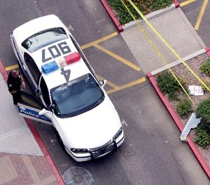A Phoenix police officer is parked in Indian Steele Park Friday, July 27, 2007 in Phoenix.