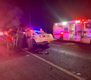 Medics respond to the scene of a crash between two sheriff's deputies Tuesday night in Putnam County, Florida.