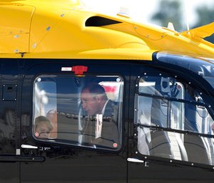 Great Britain's Prince William looks at the interior of a Airbus helicopter with his son Prince George. (Christophe Gateau/dpa via AP)