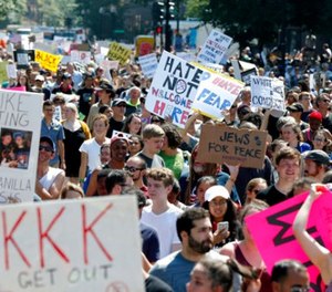 Counterprotesters stand on the periphery of a