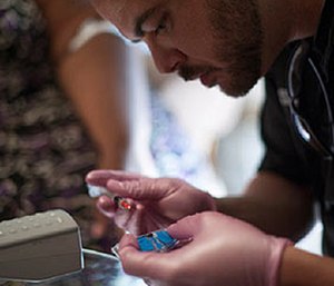 A MedStar community paramedic conducts a point-of-care test during a patient visit.