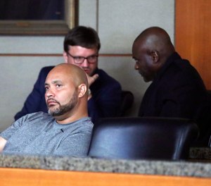 Former Houston police officers Steven Bryant, foreground, and Gerald Goines, background, turn themselves in at the Civil Courthouse, Friday, August 23, 2019, in Houston. (Karen Warren/Houston Chronicle via AP