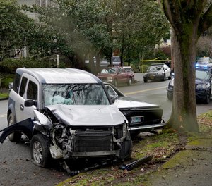 A wrecked vehicle is seen after a driver struck and injured at least five people over a 20-block stretch of Southeast Portland, Ore., before crashing and fleeing on Monday, Jan. 25, 2021, according to witnesses. (Beth Nakamura/The Oregonian via AP)