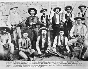 In this photo of Texas Rangers, Company D, John Hughes is seated in a chair at the far right. (Photo/Public Domain)