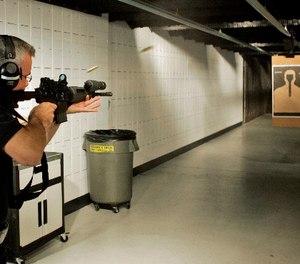 Milwaukee Police range master Sgt. James MacGillis fires an M4 rifle at the range Wednesday, Aug. 15, 2007, in Milwaukee.