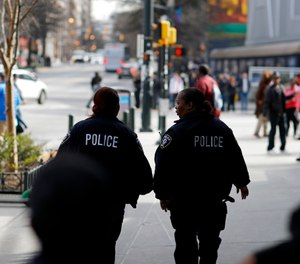 Police patrol near Mercedes-Benz Stadium ahead of Sunday's NFL Super Bowl 53 football game between the Los Angeles Rams and New England Patriots in Atlanta, Friday, Feb. 1, 2019. (AP Photo/David Goldman)