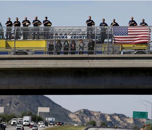 Ventura County firefighters salute as the hearse carrying the body of Nancy Reagan makes its way to the Ronald Reagan Presidential Library.