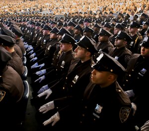 Members of New York Police Academy's July 2018 graduating class of 726 new NYPD police officers from more than 41 countries, show their white-gloved hands while seated during graduation ceremony, Monday July 2, 2018, in New York.