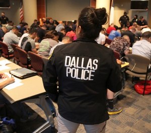 Potential police recruits take a test during an applicant processing event at police headquarters in Dallas, Thursday, Sept. 7, 2017.