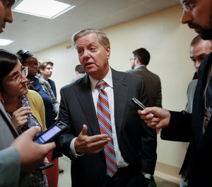 Senate Judiciary Committee Chairman Lindsey Graham, R-S.C., talks to reporters on his way to the Senate chamber for votes on federal judges as a massive budget pact between House Speaker Nancy Pelosi and President Donald Trump is facing a key vote in the GOP-held Senate later, at the Capitol in Washington, Wednesday, July 31, 2019.