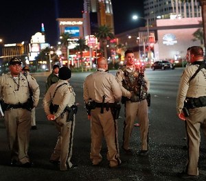 Las Vegas police officers stand along the Las Vegas Strip, Sunday, Dec. 31, 2017, in Las Vegas. (AP Photo/John Locher)