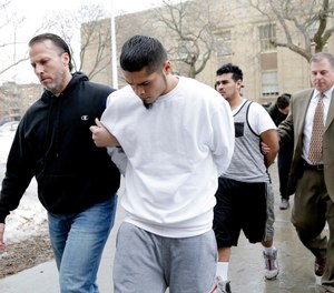 In this Jan. 11, 2018 file photo, suspected members of the MS-13 gang are escorted to their arraignment in Mineola, N.Y.