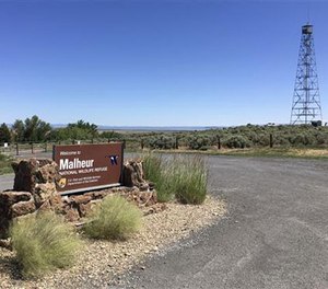 This photo taken June 21, 2016, shows a locked gate that blocks the road at the headquarters of the Malheur National Wildlife Refuge near Burns, Ore. (AP Image)