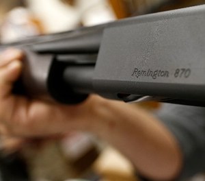 In this March 1, 2018, file photo the Remington name is seen etched on a model 870 shotgun at Duke''s Sport Shop in New Castle, Pa. (AP Photo/Keith Srakocic, File)