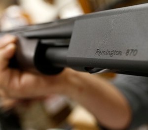 In this March 1, 2018, file photo the Remington name is seen etched on a model 870 shotgun at Duke''s Sport Shop in New Castle, Pa.