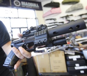 Jordan Baylon, 22, holds a realistic-looking air gun.