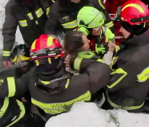 Italian firefighters extract a woman alive from under snow and debris of a hotel that was hit by an avalanche.
