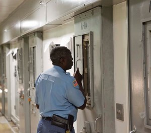 Capt. Dwain Williams checks on a prisoner in the the Special Management Unit, known as high-max at the Georgia Diagnostic and Classification Prison, Tuesday, Dec. 1, 2015, in Jackson, Ga.