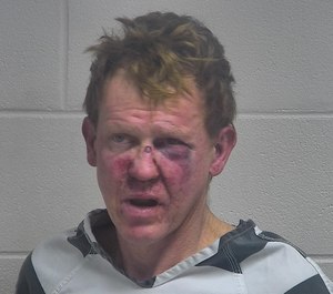 Richard Brown, 49, is accused of setting his house on fire with four family members inside. Police say five rifles were stored near where Brown was hiding before being apprehended. (Photo/Oldham County Detention Center)