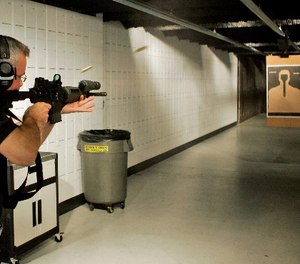 Milwaukee Police range master Sgt. James MacGillis fires an M4 rifle at the range Wednesday, Aug. 15, 2007, in Milwaukee. (AP Photo/Morry Gash)