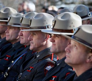 In this Jan. 1, 2019, file photo, members of the Rhode Island State Police attend inauguration ceremonies at the State House in Providence, R.I.
