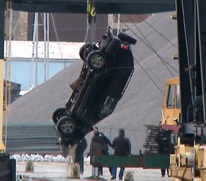 This Jan. 1, 2019 screen shot from WISN-TV shows authorities pulling out an SUV from the Kinnickinnic River, a day after it crashed into the river during a police chase. A toddler, her young mother and a man died when their vehicle drove into a frigid river while being chased by the Milwaukee Police. (WISN-TV via AP)