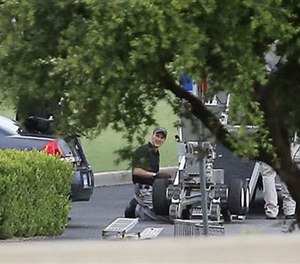 File Photo - Police appear to set up a remotely operated robot during a stand off with a gunman on June 13, 2015 in Hutchins, Texas. (AP Images)