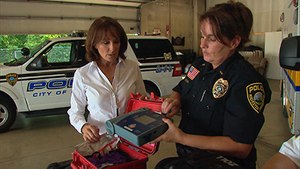 A Rochester Police Officer shows a reporter one of the department''s AEDs