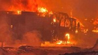 Photo: Vt. fire engine overwhelmed by flames in lumberyard blaze