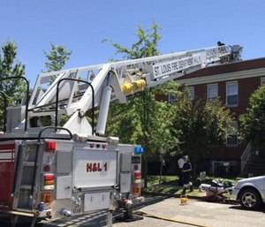 The fire captain was able to walk down a ladder, assisted by other firefighters, to a waiting ambulance. (Photo/St. Louis Fire Department)