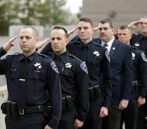Officers salute before funeral services for Corona at the University of California, Davis, Friday, Jan. 18, 2019, in Davis, Calif. Corona was was shot and killed Jan. 10, responding to scene of a three-car crash in Davis. Police say gunman Kevin Douglas Limbaugh, 48, not involved in the crash, rode up on a bicycle and without warning, opened fire on Corona. (AP Photo/Rich Pedroncelli)