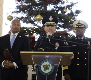 Pasadena Police Chief Phillip Sanchez, center, speaks about safety issues ahead of next week's 128th Rose Parade as he is joined by Pasadena Fire Chief Bertral Washington, background right, and Rob Savage, special agent in charge of the U.S. Secret Service Wednesday, Dec. 28, 2016, in Pasadena, Calif.