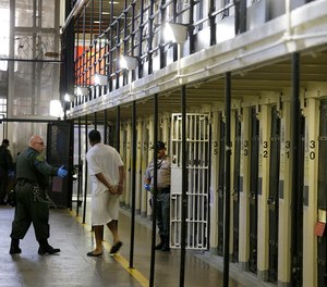 In this Aug. 16, 2016 file photo, a condemned inmate is led out of his east block cell on death row at San Quentin State Prison in San Quentin, Calif.