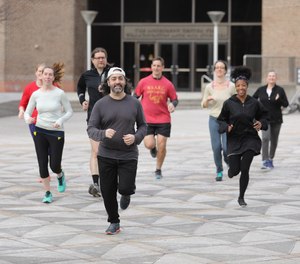 Mario Giorno (middle) and other members of the Annenberg (Lunchtime) Running Club meet three times a week at the plaza at 36th Street and Locust Walk in University City.