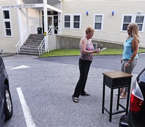 A resident counts out her cash as she purchases a table in the