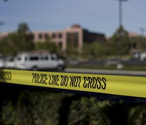Yellow tape is strung around the Inland Regional Center, the site of a shooting rampage that killed 14 people Tuesday, Dec. 8, 2015, in San Bernardino, Calif.