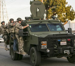 In this Dec. 2, 2015 file photo authorities search an area near where police stopped a suspected vehicle in San Bernardino, Calif.