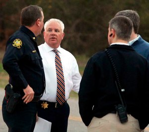 Berkeley County Sheriff Duane Lewis, second from left, talks with sheriff department personnel after deputies and other law enforcement agents responded to an active shooter situation in Huger, S.C. (Brad Nettles/The Post And Courier via AP)