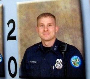 This April 13, 2011, file photo, shows an image of Officer Jonathan Schmidt, right, hanging at the Trumann, Ark., police station.