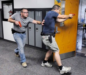 Justin Royse, left, and Dakota Steele practice moving down a hallway during active shooter training at Daleville High School in Daleville, Ind. on Saturday, June 23, 2018. (Don Knight)/The Herald-Bulletin via AP)