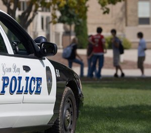 A police car sits outside Green Bay East High School Friday, Sept. 15, 2006, in Green Bay, Wis. (AP Photo/ Morry Gash)