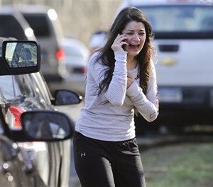 In this Dec. 14, 2012, file photo, Carlee Soto uses a phone to get information about her sister, Victoria Soto, a teacher at the Sandy Hook elementary school.