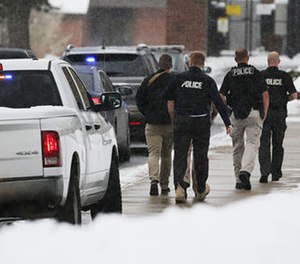 Officials respond to Mueller Park Junior High after a student fired a gun into the ceiling in Bountiful, Utah on Thursday, Dec. 1, 2016. (Ravell Call/The Deseret News via AP)