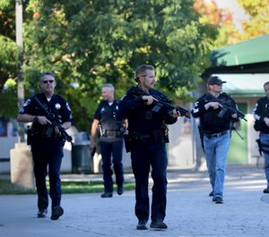 Santa Rosa police officers carry guns as they search the campus of Ridgway High School for suspects after a shooting at the school. (Beth Schlanker/The Press Democrat via AP)