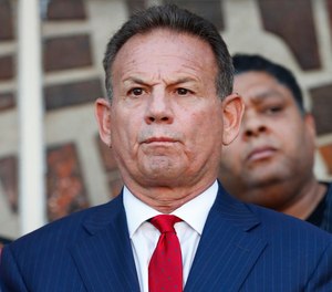 In this Jan. 11, 2019, photo, suspended Broward County Sheriff Scott Israel listens to comments by his attorney at a news conference after new Florida Gov. Ron DeSantis suspended Israel in Fort Lauderdale, Fla., over his handling of February's massacre at Marjory Stoneman Douglas High School.